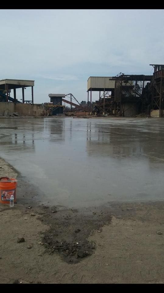 A large body of water with buildings in the background