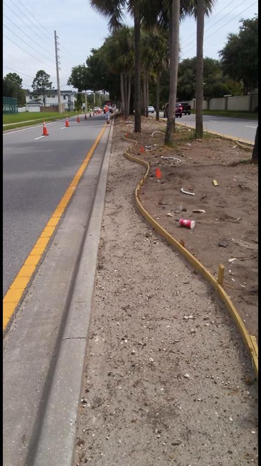A road with a yellow line on the side of it