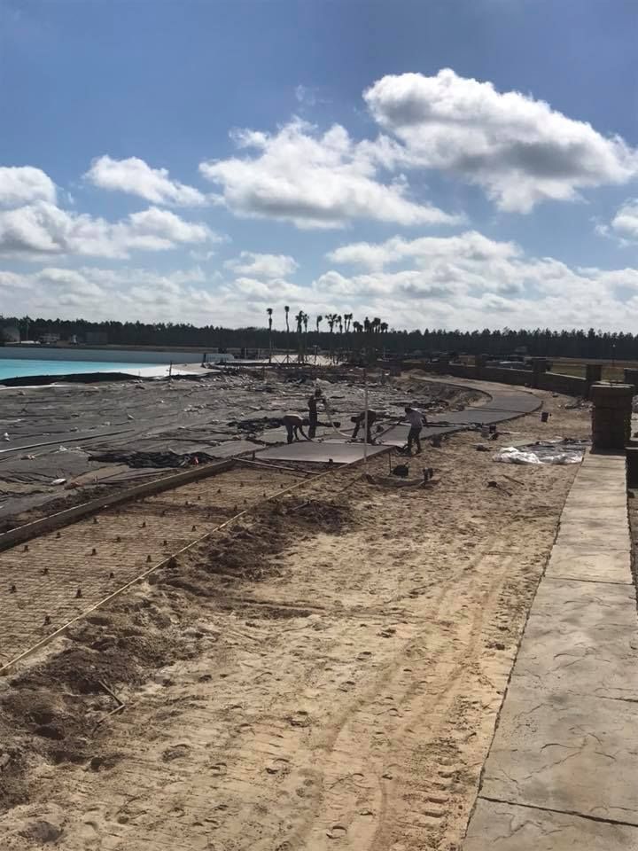 A construction site with a blue sky and clouds in the background