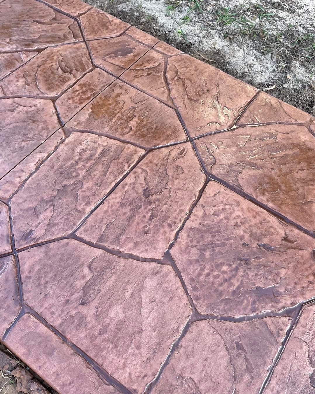 A close up of a concrete walkway with a geometric pattern.