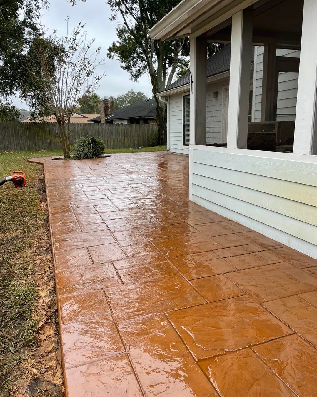 A concrete walkway is being built in front of a house.