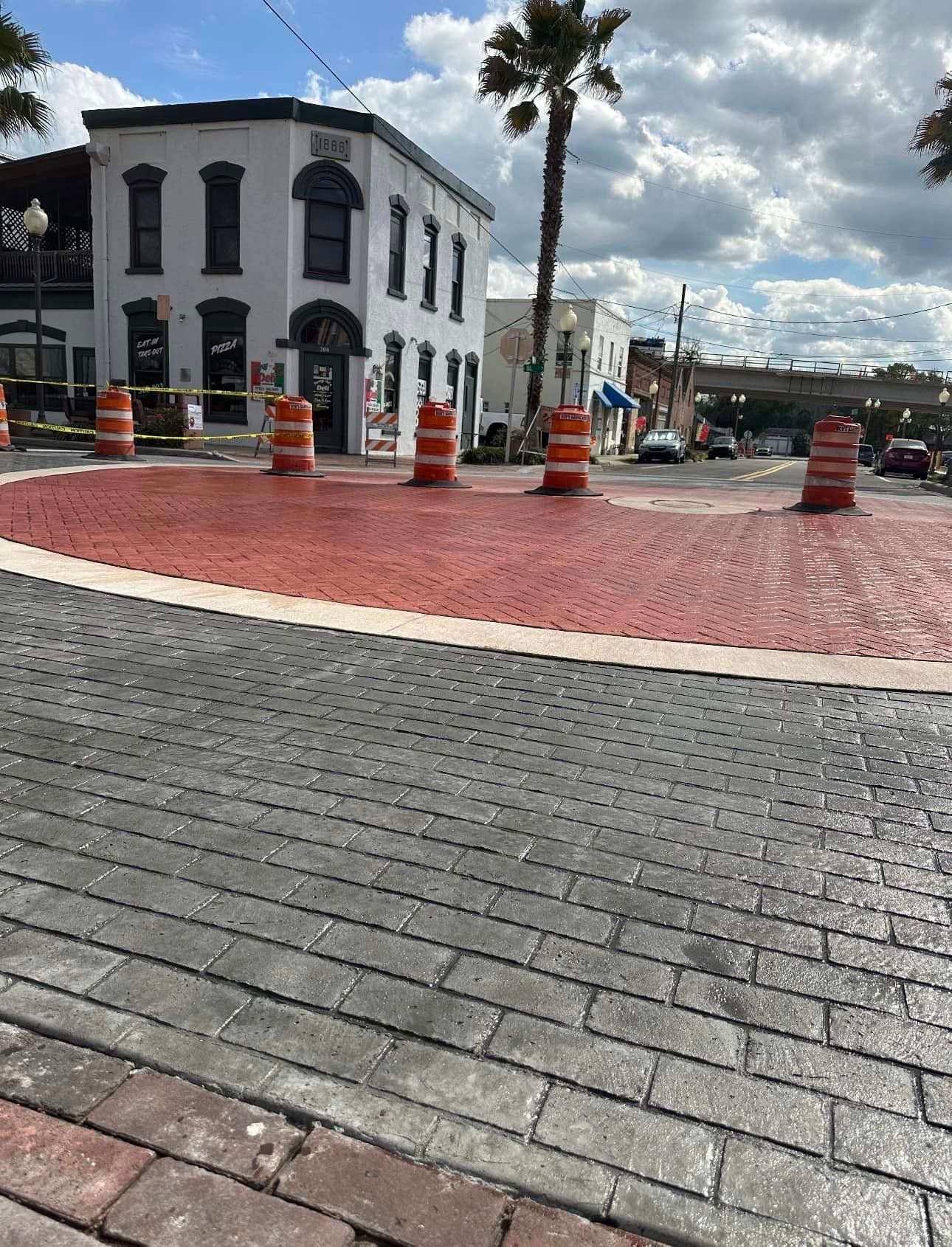 A brick house with a wooden deck in front of it.