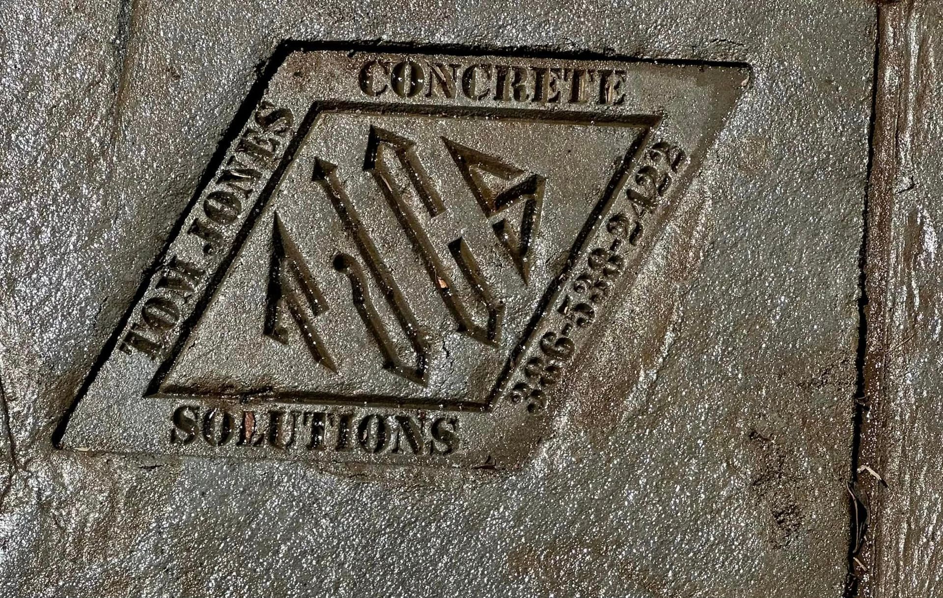 A close up of a concrete sign that says concrete solutions
