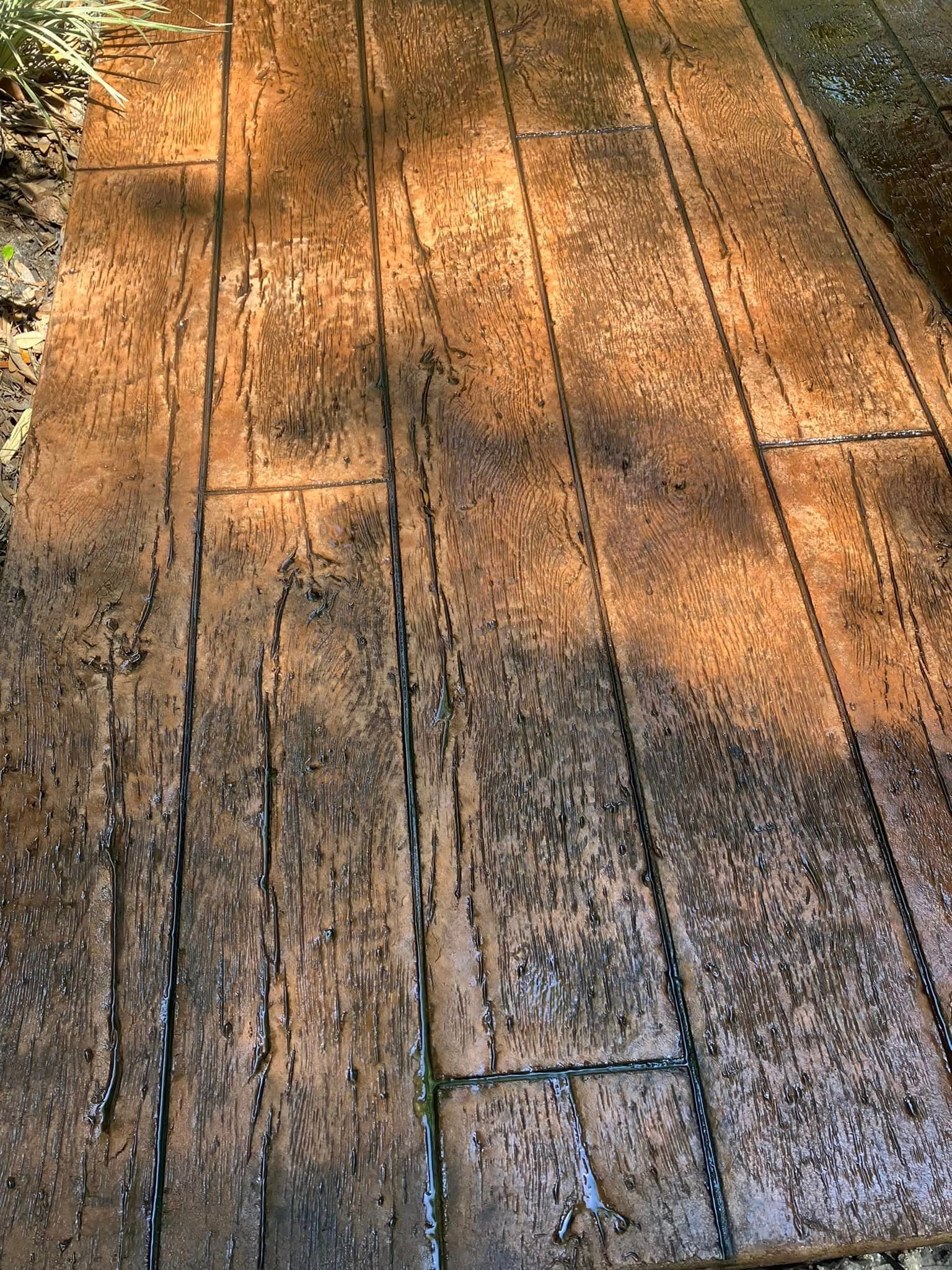 A close up of a concrete walkway that looks like wood.