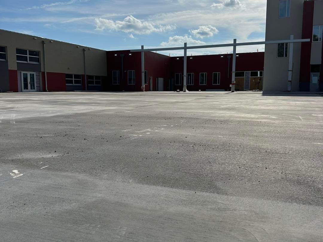 An empty parking lot in front of a large building