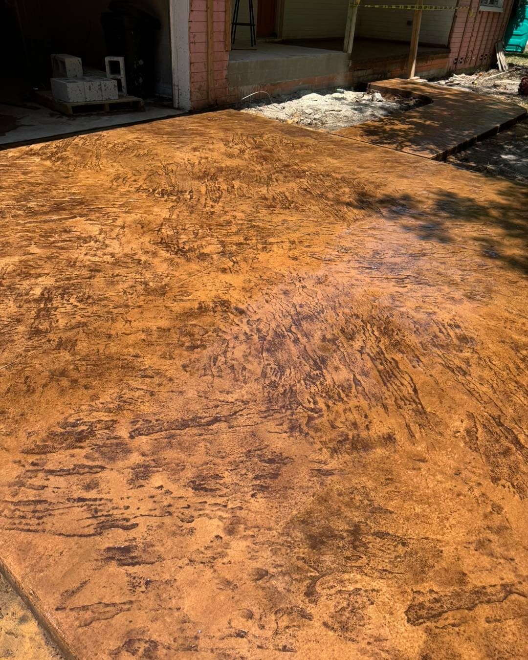 A close up of a concrete driveway in front of a garage.