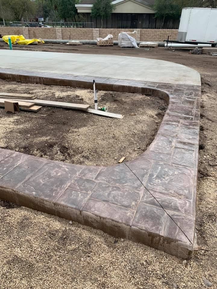 A concrete walkway is being built in a yard.
