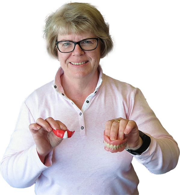 anne hughes holding a mouth guard and duentures