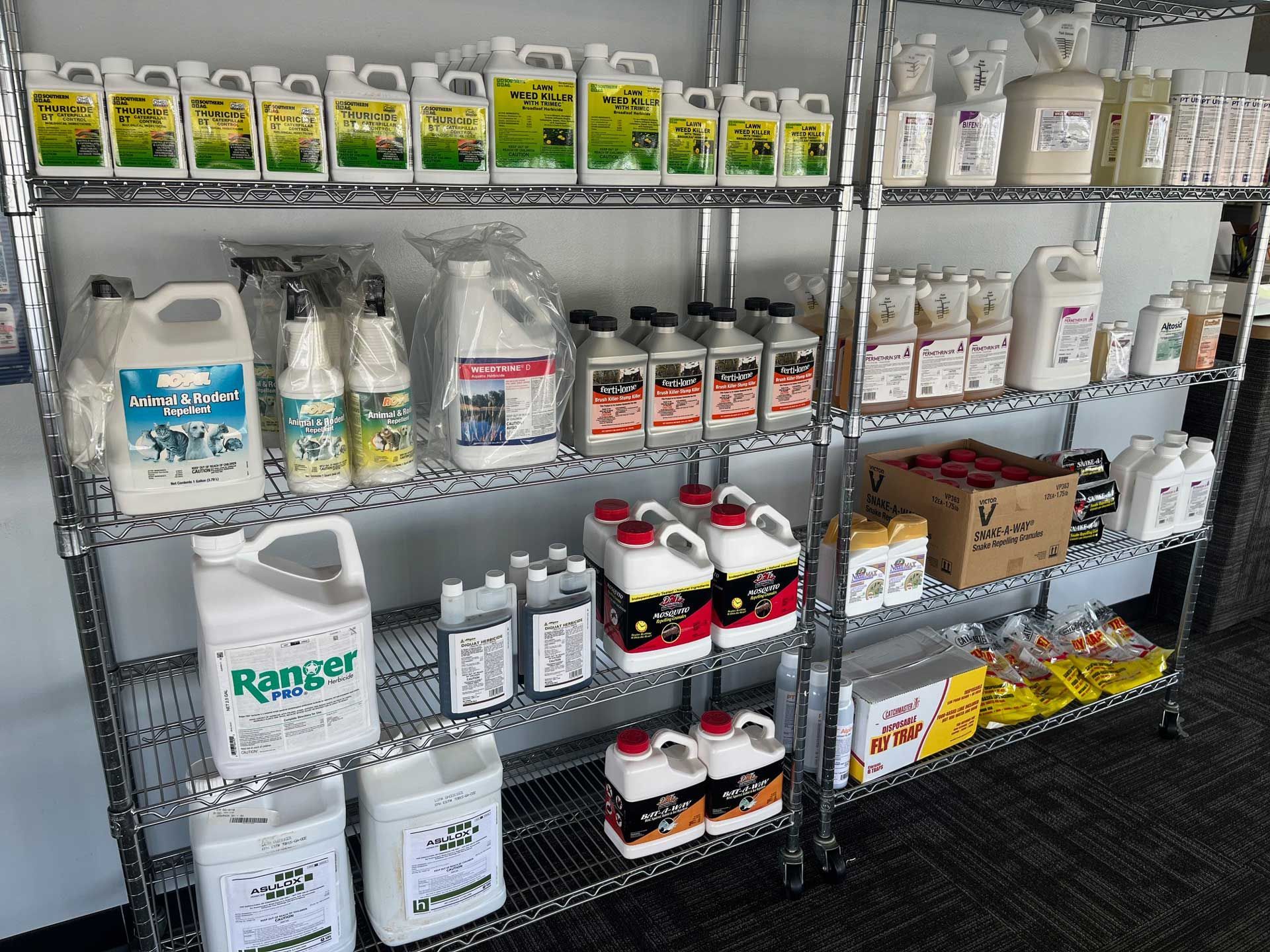 A shelf filled with many different types of cleaning supplies