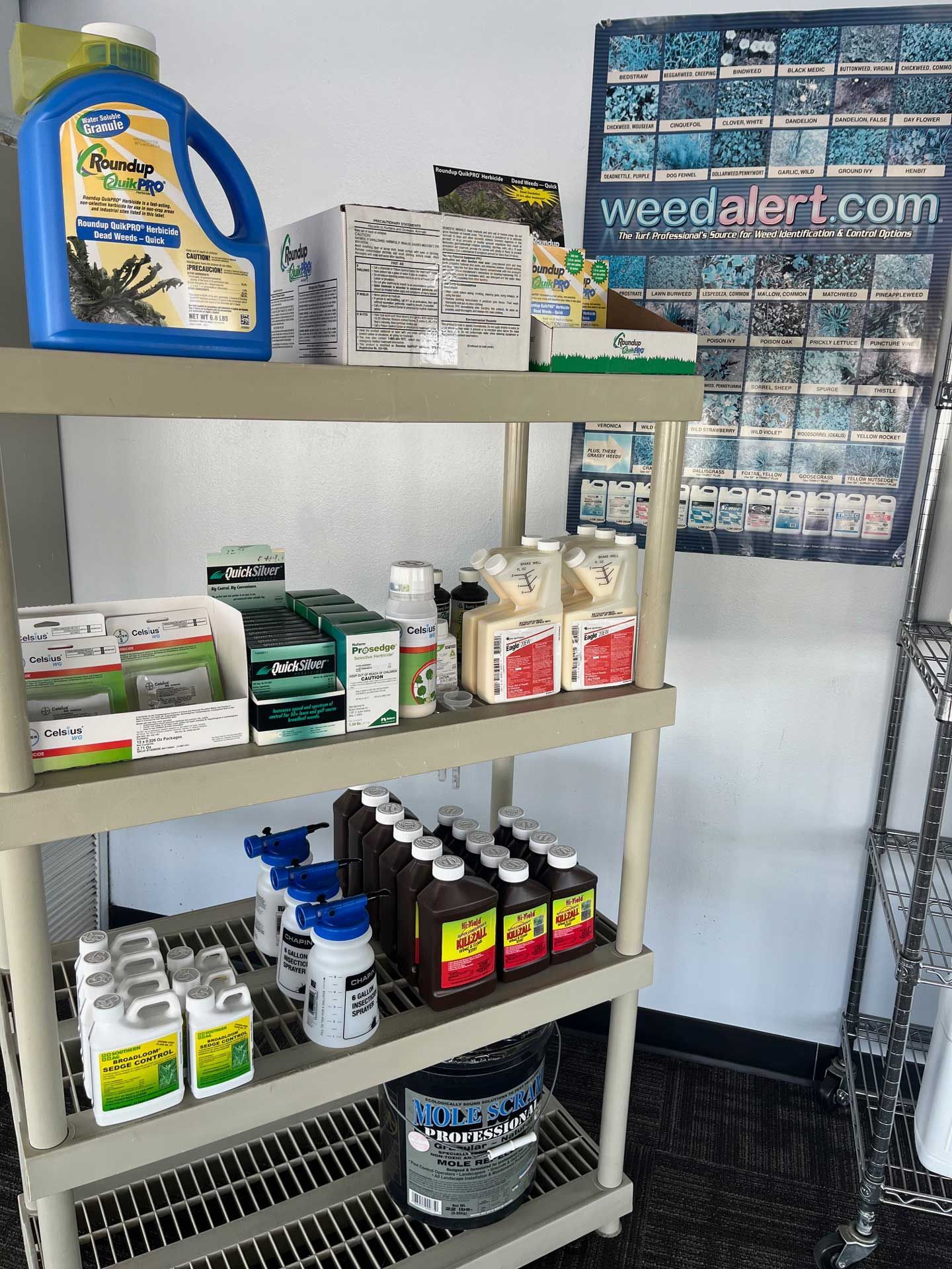 A shelf filled with lots of different types of weed killers
