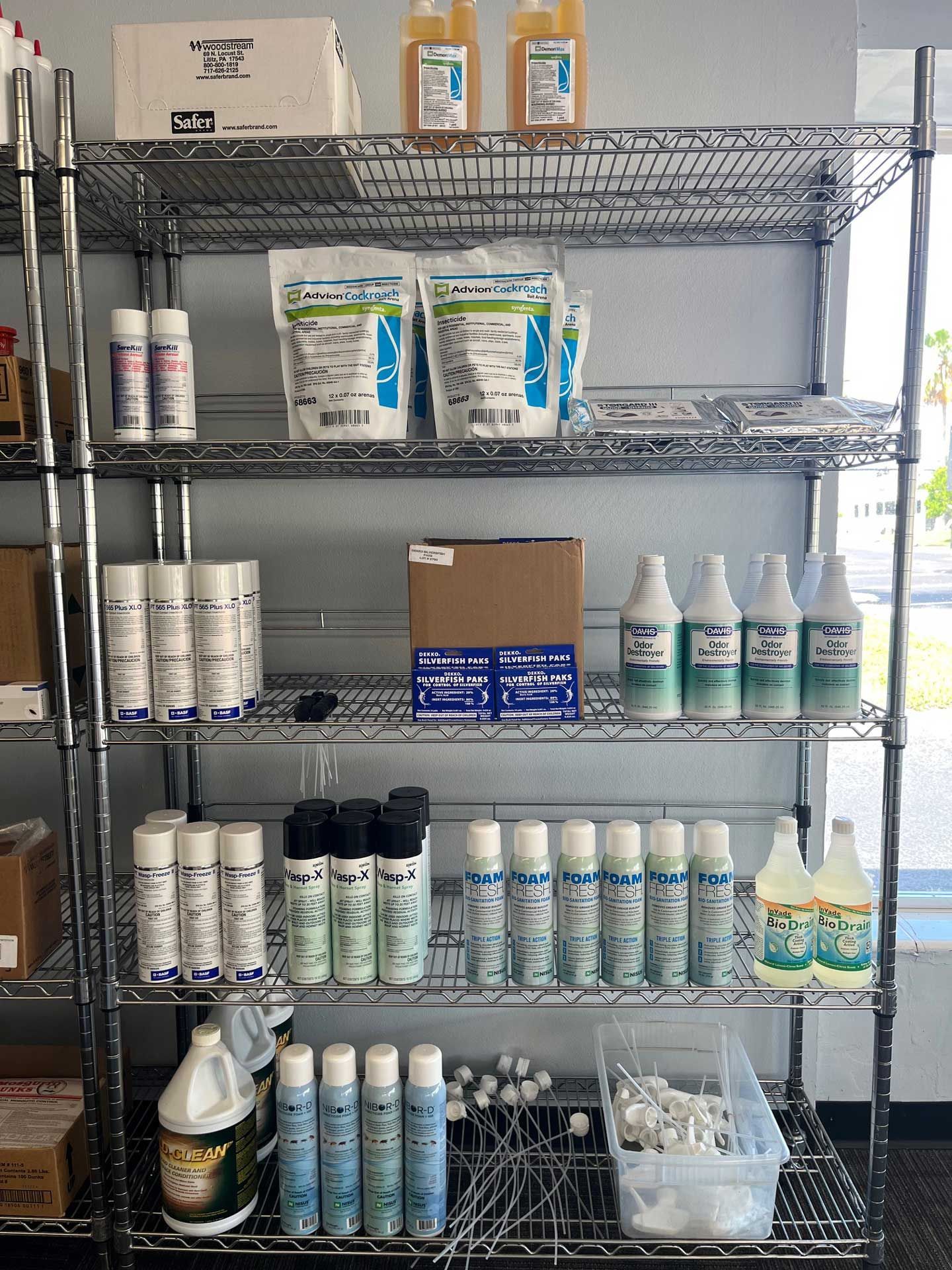 A shelf filled with bottles and bags of chemicals.