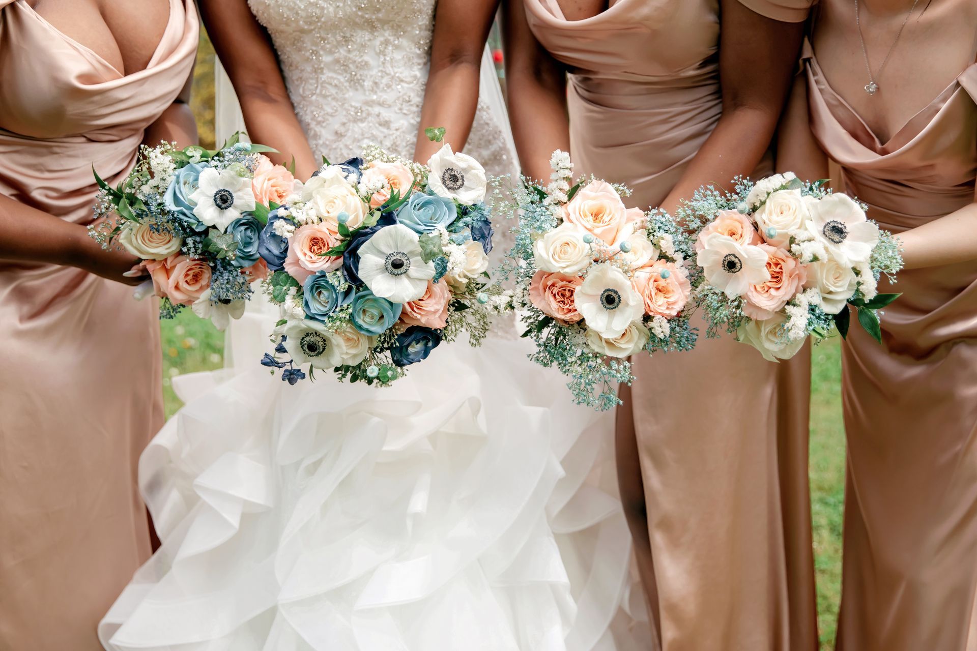 A bride and her bridesmaids are holding bouquets of flowers.