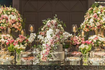 A bouquet of pink and white flowers in a vase on a table.