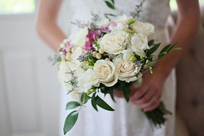 A vase filled with pink flowers on a table.