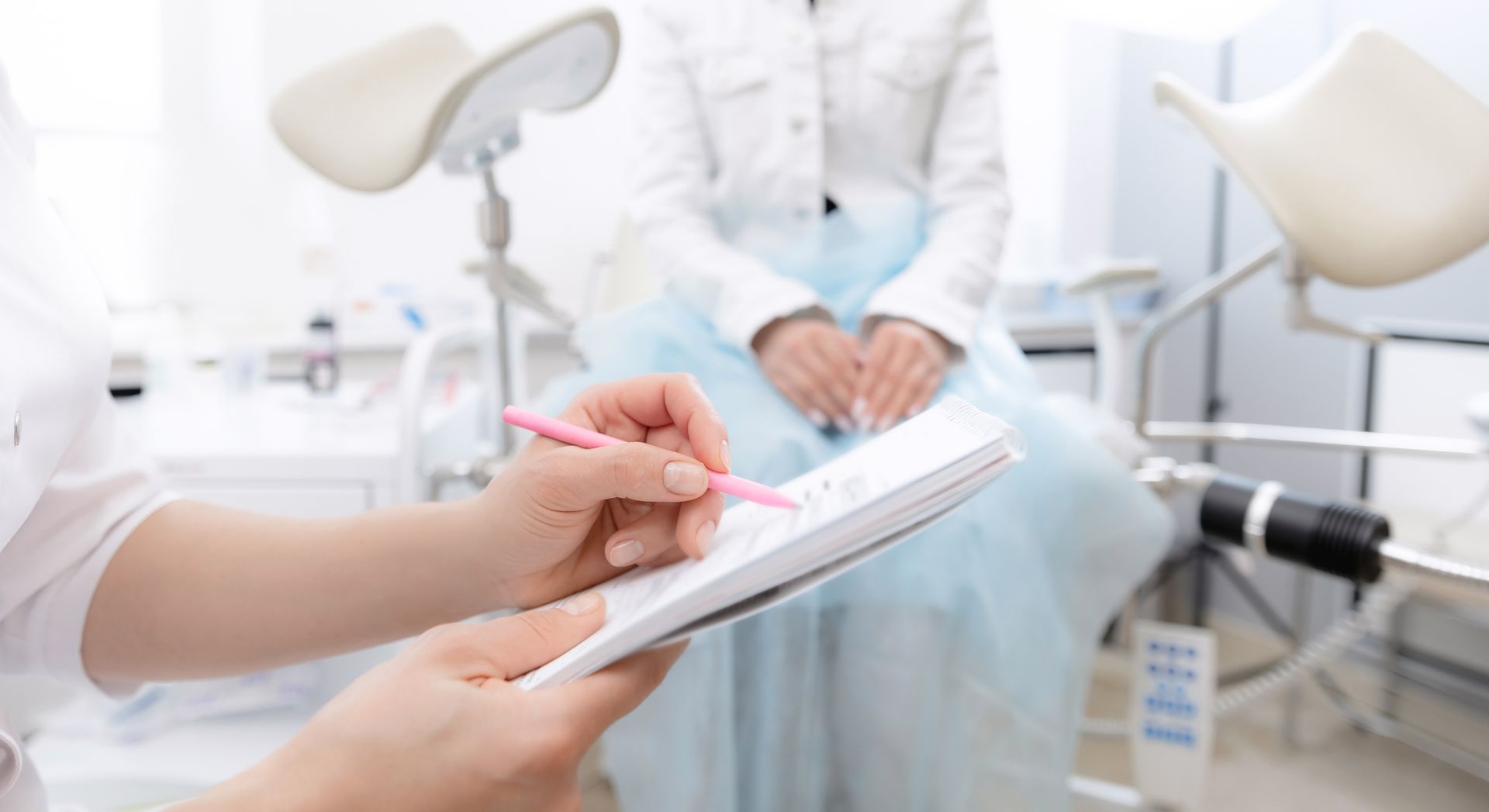 Gynecologist consulting young female patient, showcasing care at a modern women's health clinic. Gynecologist consulting young female patient, showcasing care at a modern women's health clinic.