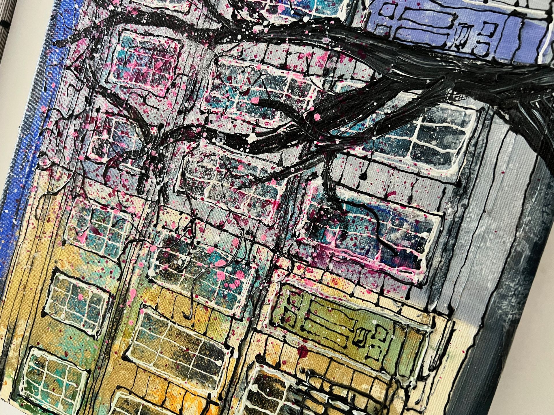 Painting of a building with visible windows under a tree with dark branches, splashes of color.