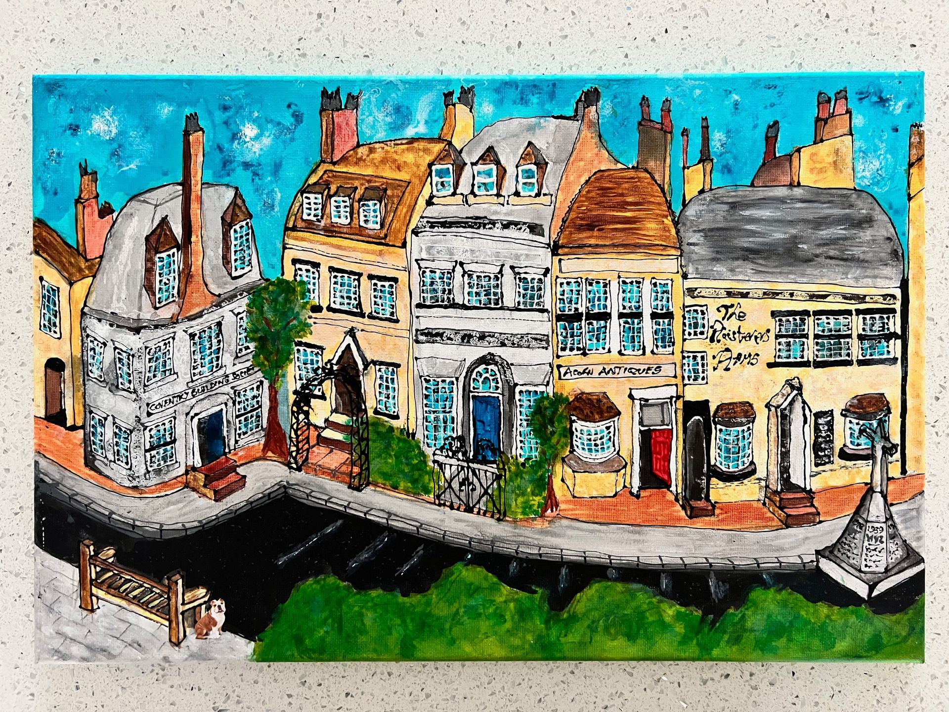 Colorful painting of a European street with several buildings, a blue sky, and green shrubbery.