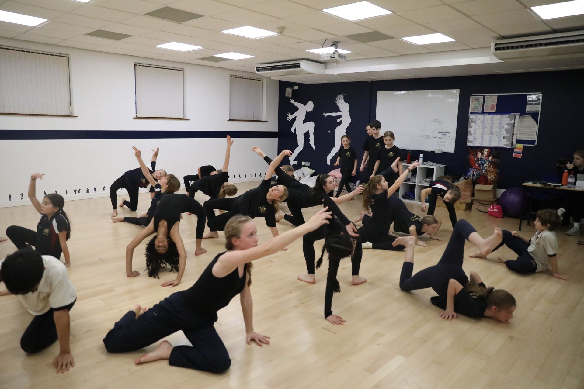 A group of children are dancing in a dance studio.