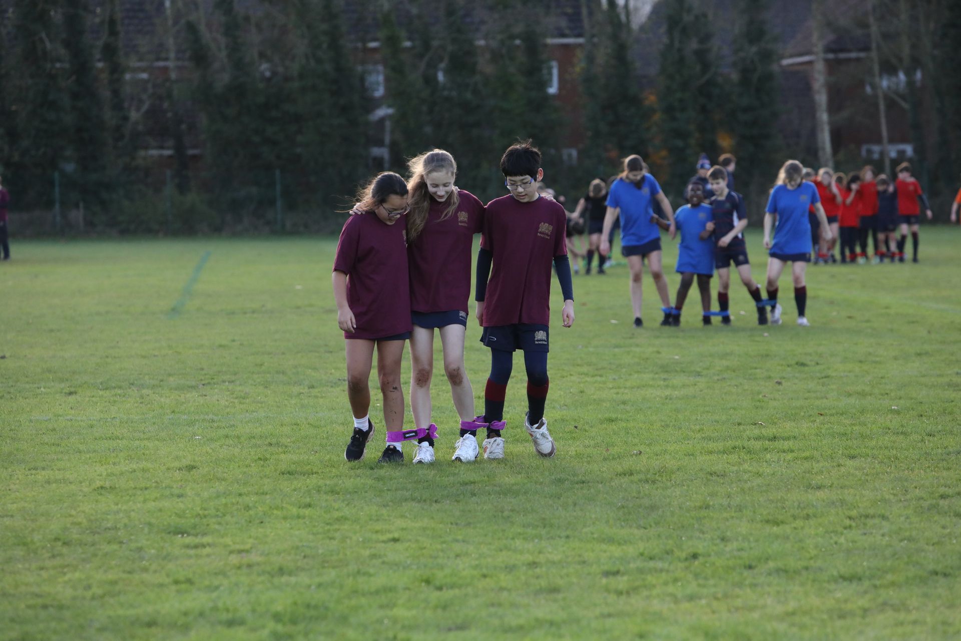 A group of children are playing a game on a field.