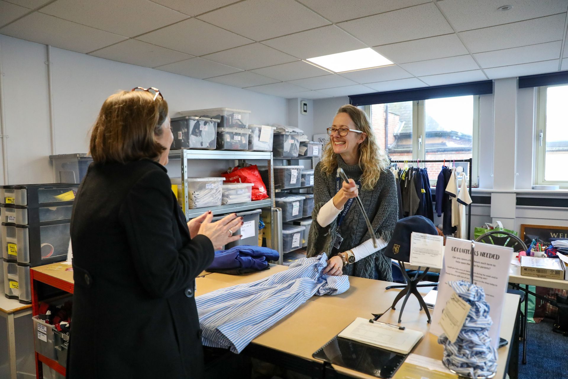 Two boys in school uniforms are sitting at a desk in a classroom.