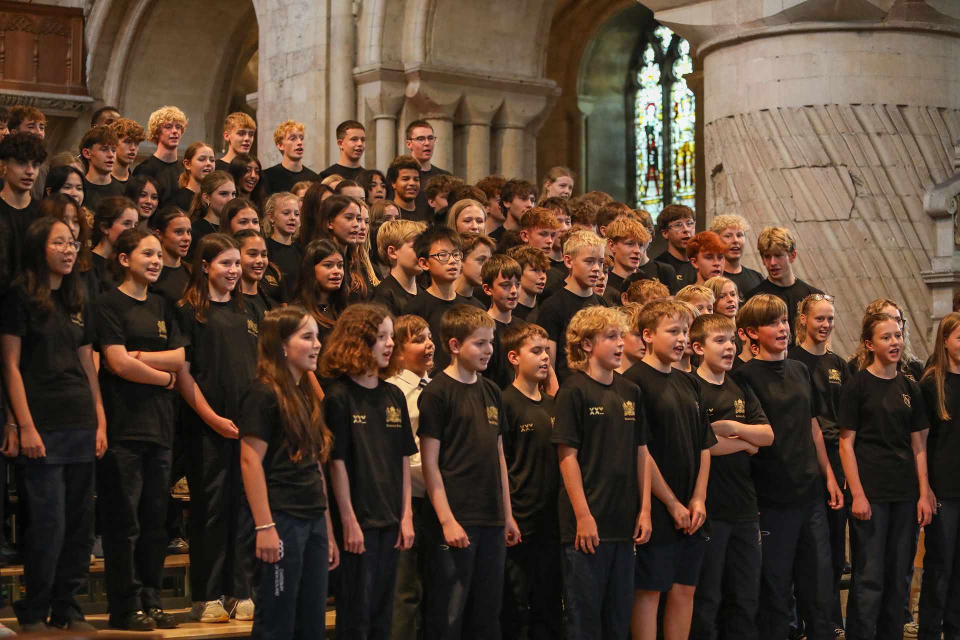 A large group of people are singing in a church