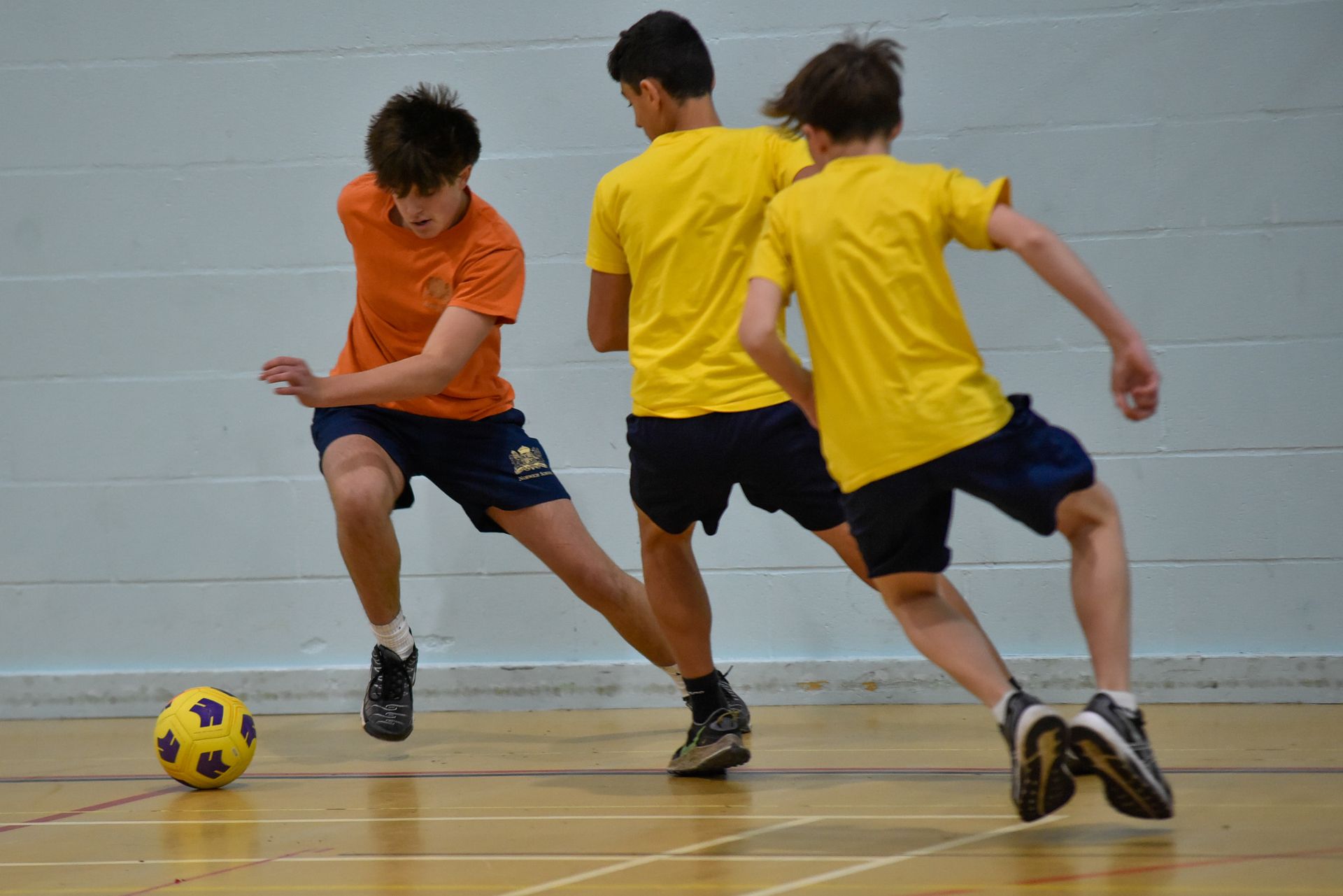 A group of children are playing with tires in a field.