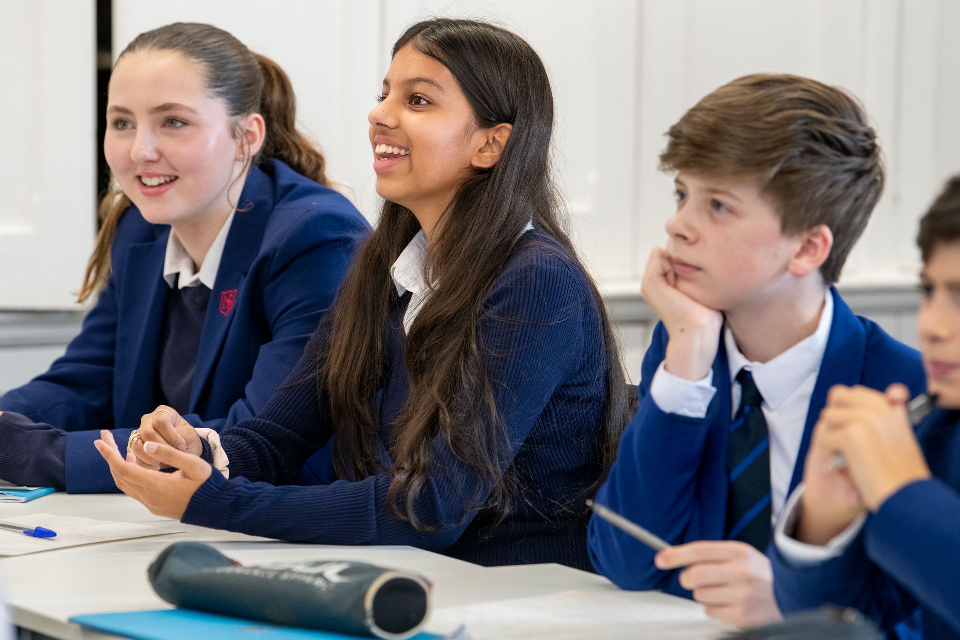 A boy and a girl are playing with a water fountain.
