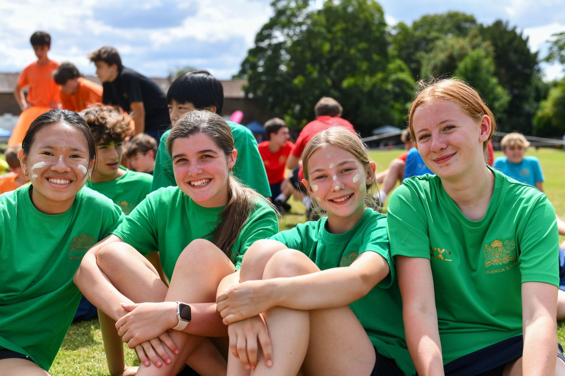 A group of young boys are playing basketball on a court.