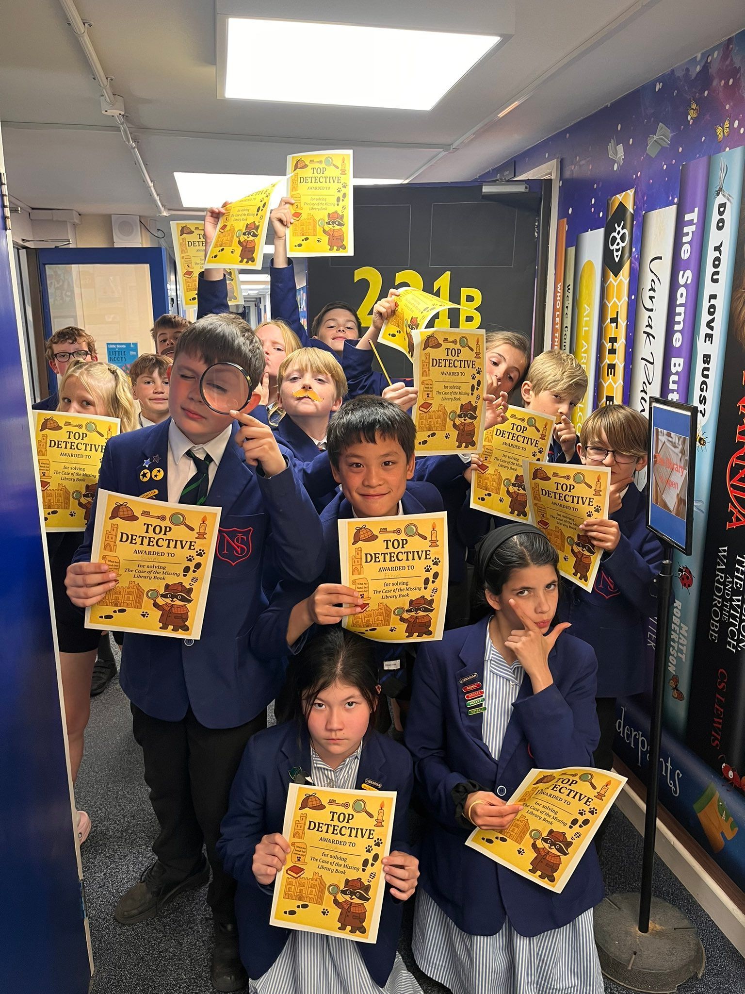 A group of children are standing in a hallway holding signs.