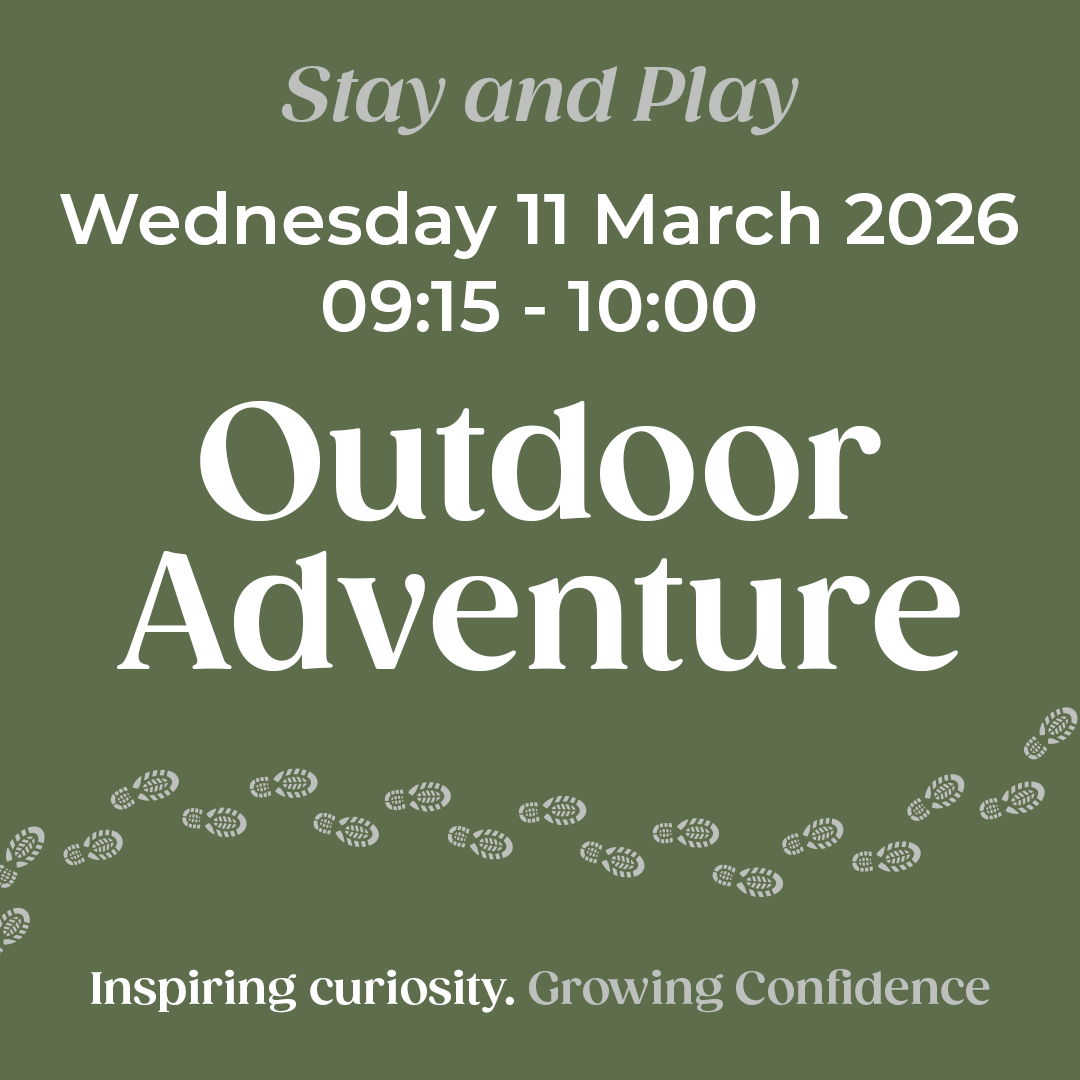 Two pupils sitting at a table in a classroom working on a project.