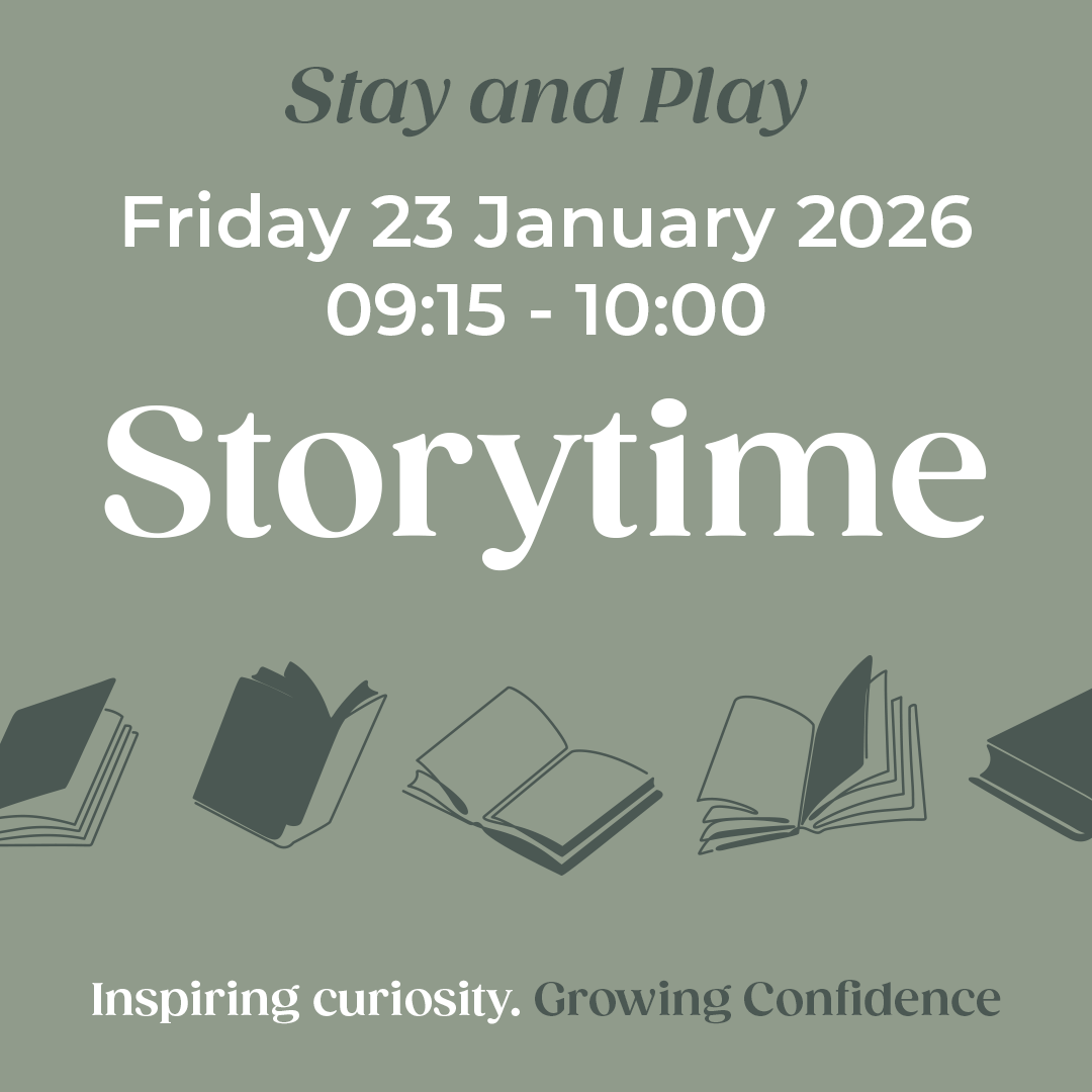 Two pupils sitting at a table in a classroom working on a project.