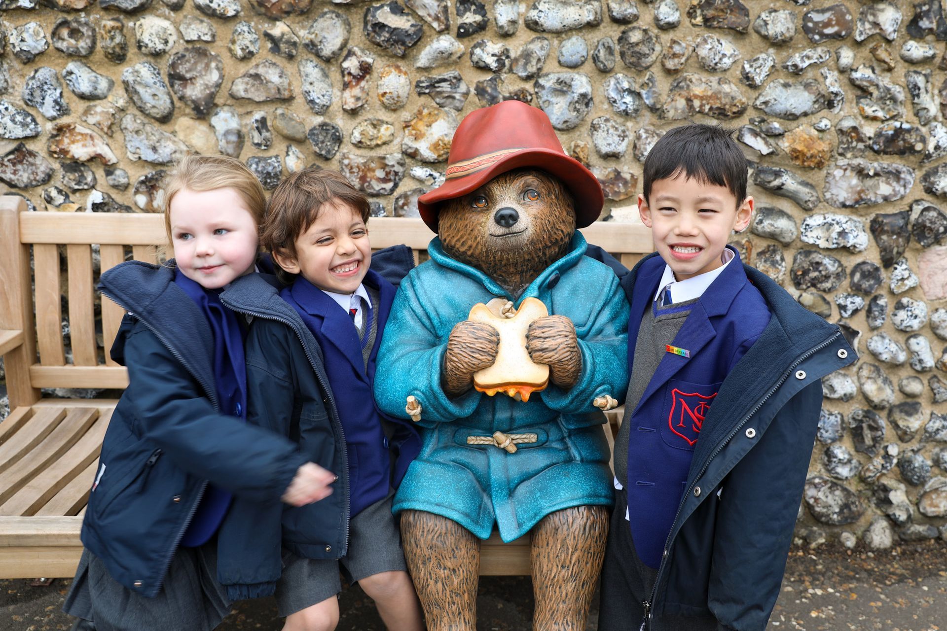 Two pupils sitting at a table in a classroom working on a project.