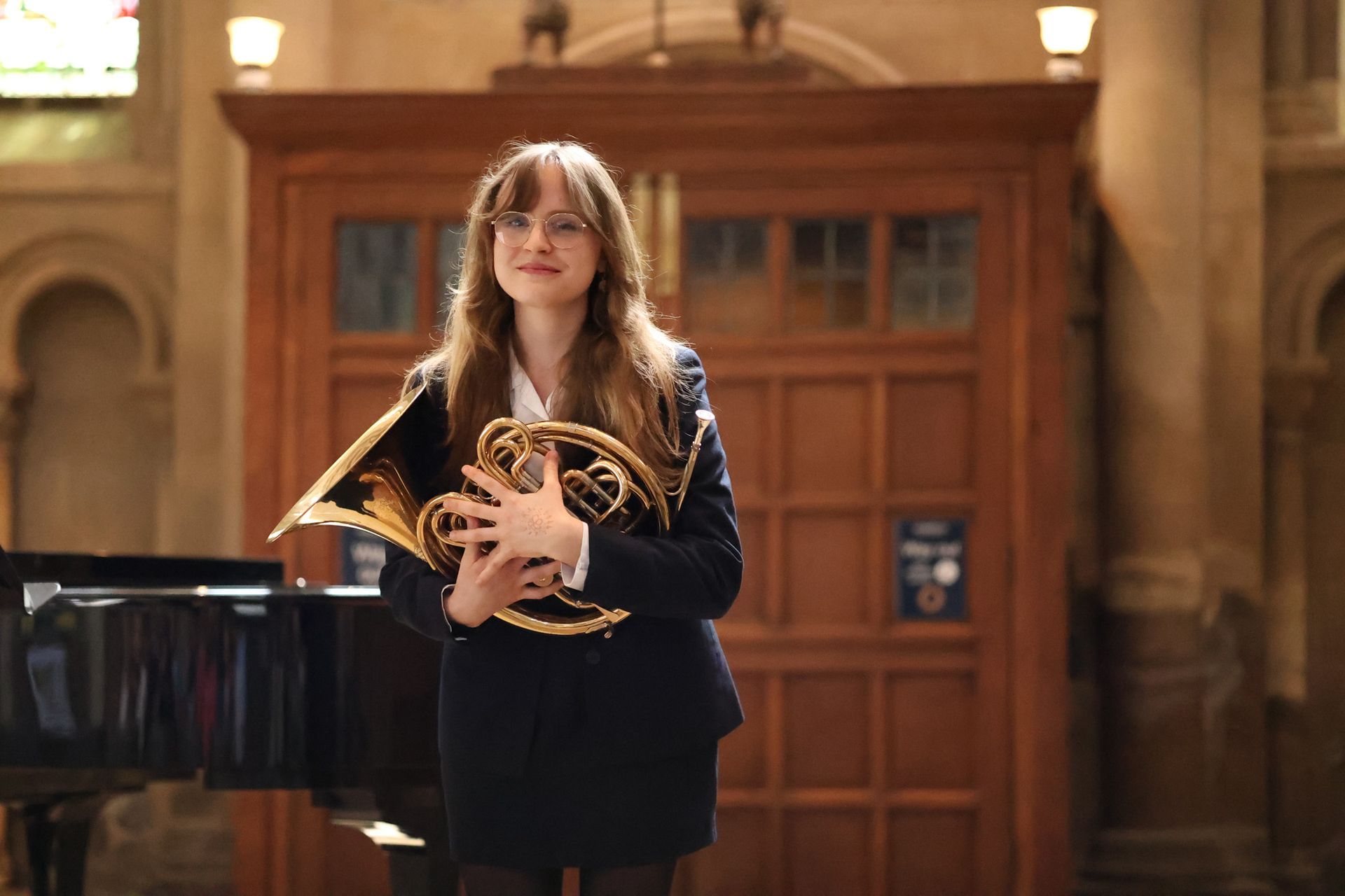 A group of people are sitting in a church watching a concert.