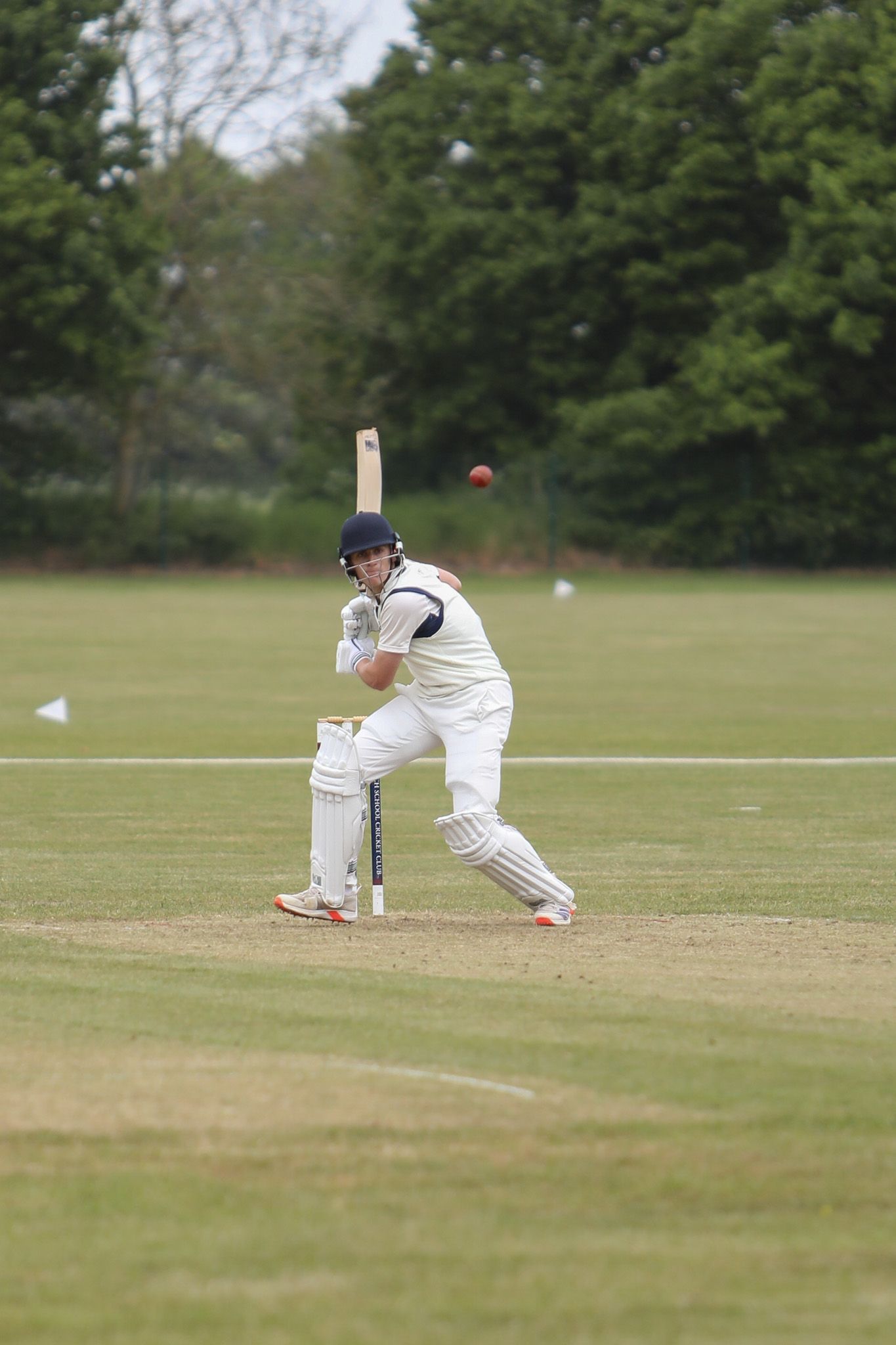 A group of people are rowing boats on a river.
