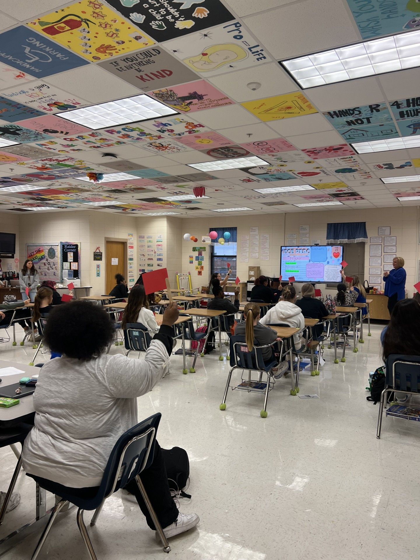 A large flat screen tv is sitting on a stand in a room.