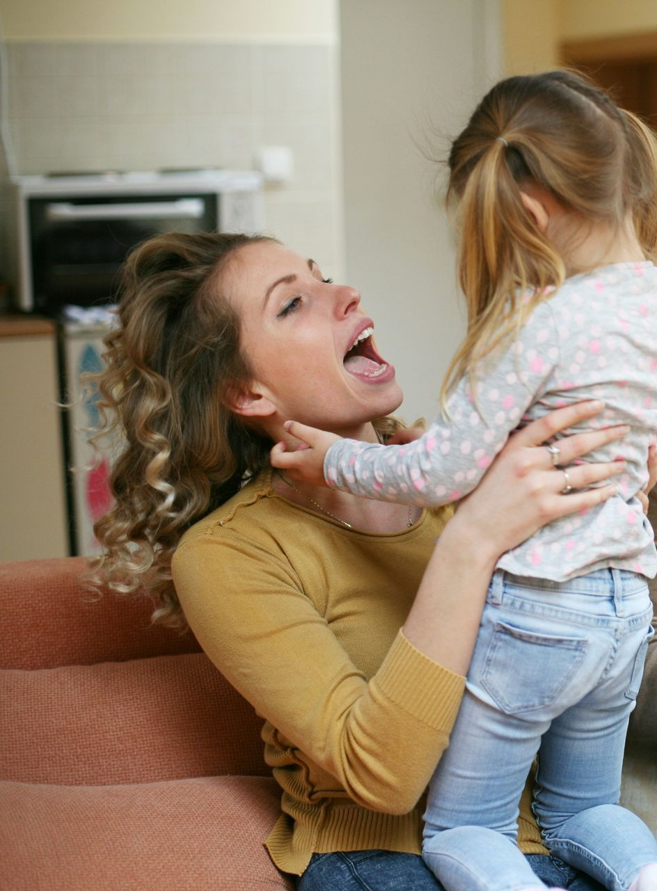 A man and a woman are posing for a picture in front of a fox valley metro police badge.