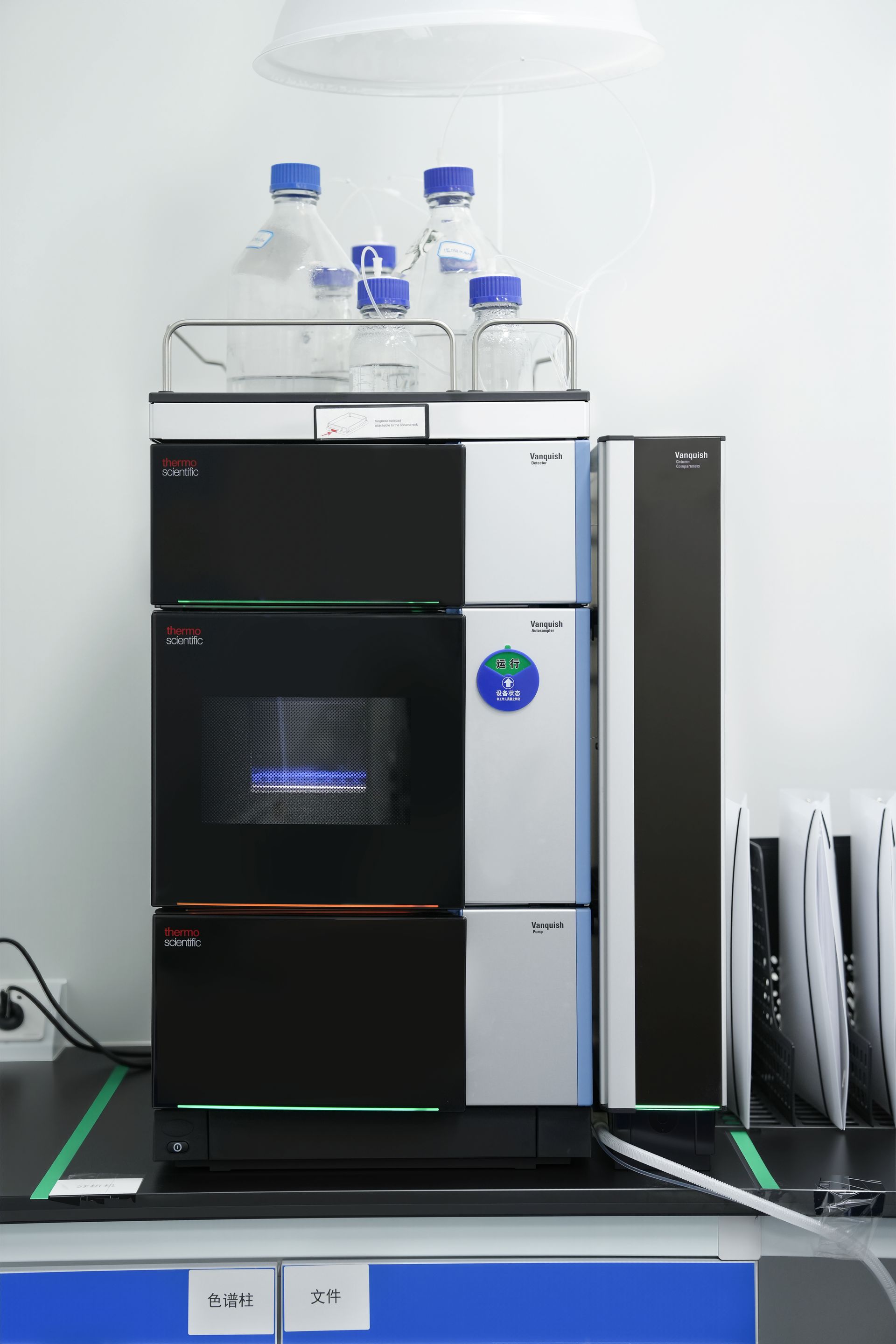 High-performance liquid chromatography system in a lab setting, with various components and liquid reservoirs.