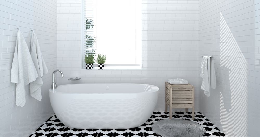 A Bathroom with A Bathtub, Sink, and Window — Affordable Tiling & Waterproofing in Kirwan, QLD