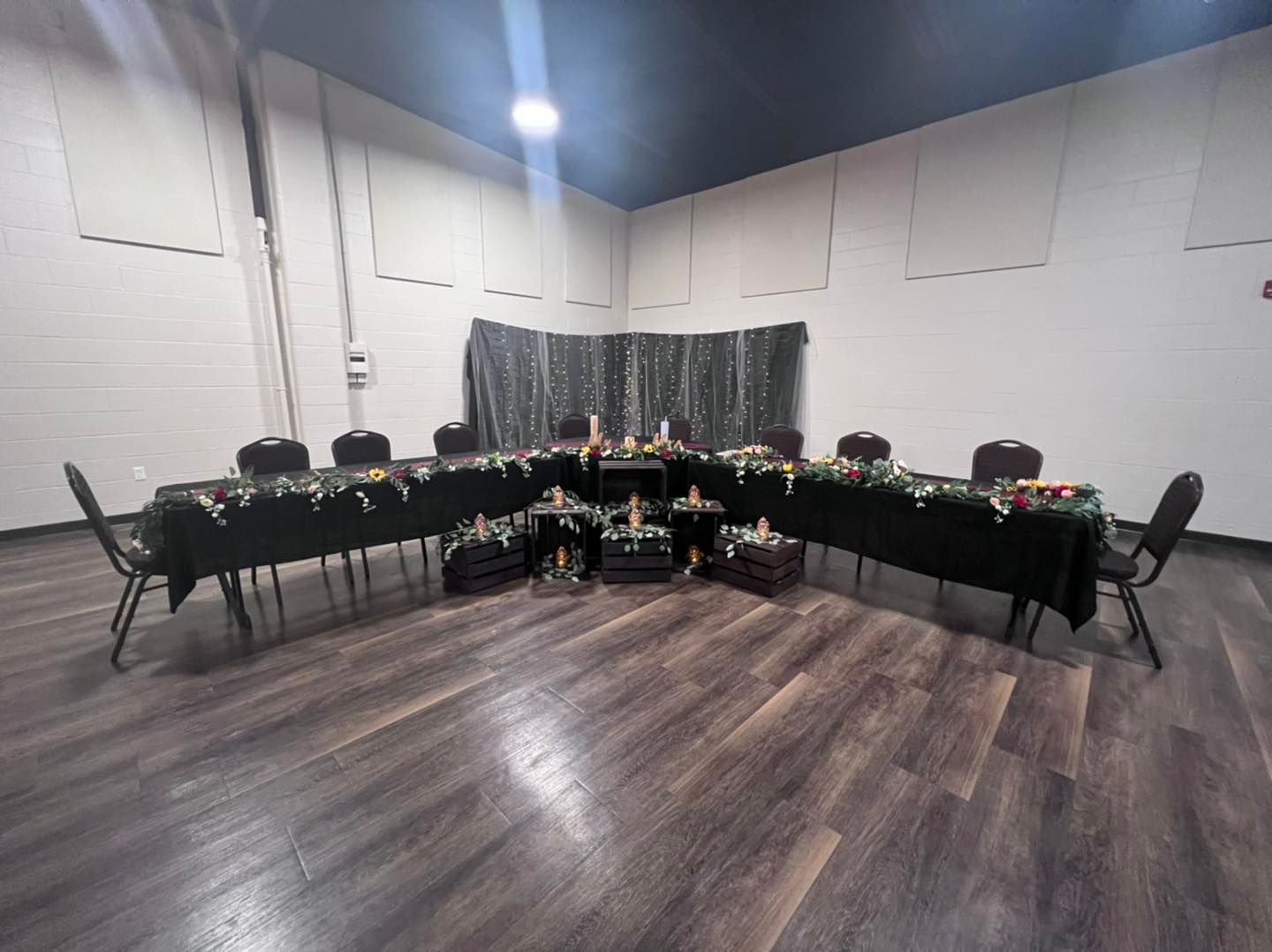 There are many tables and chairs in the room.