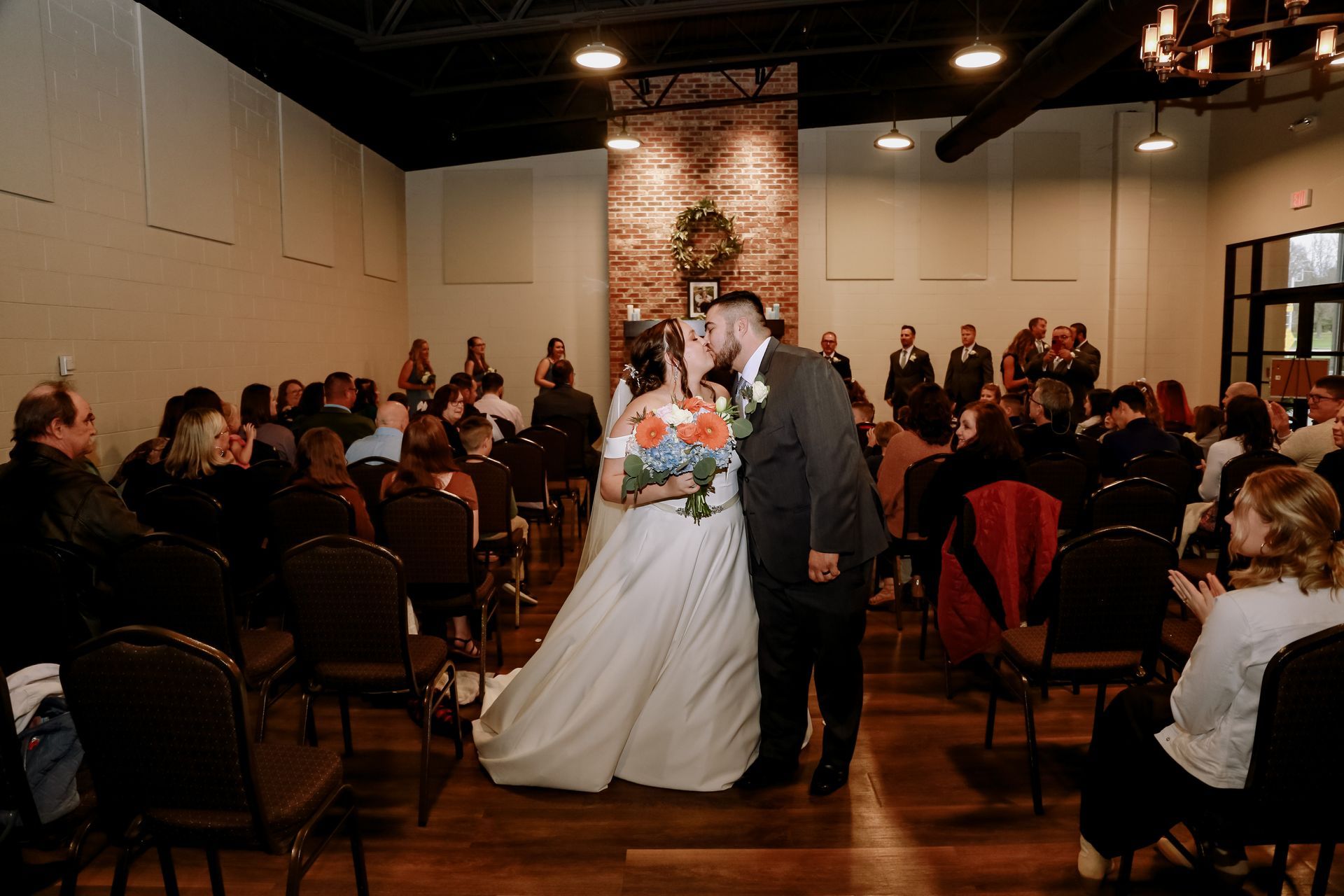 A table set for a wedding reception with flowers and candles on it.