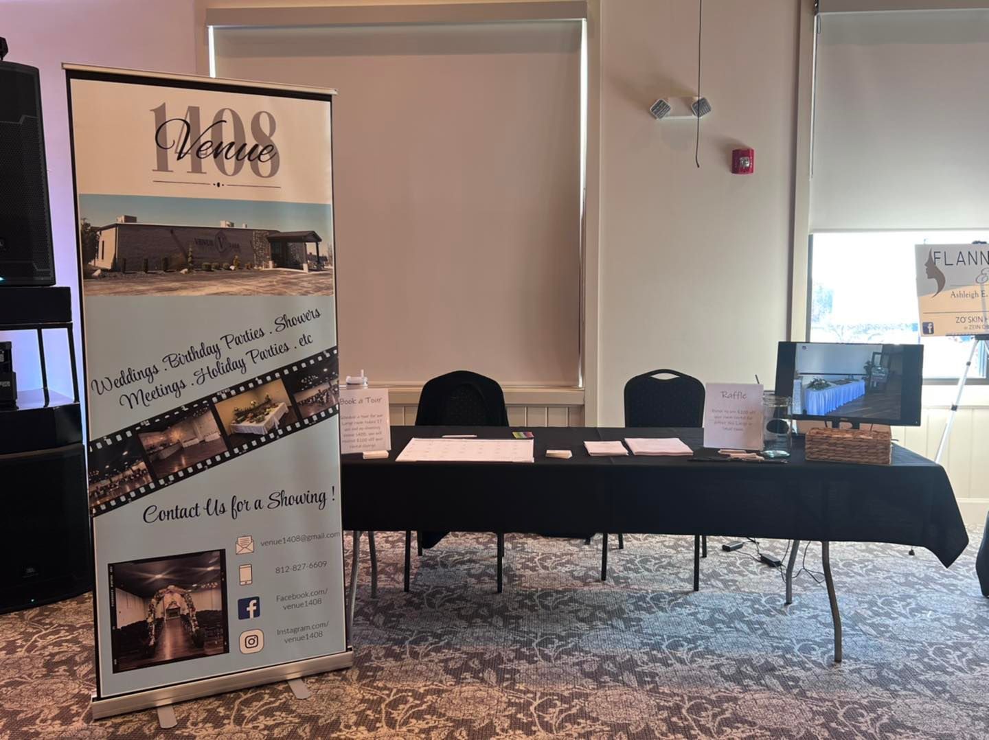 A group of people are standing in a room talking to each other.