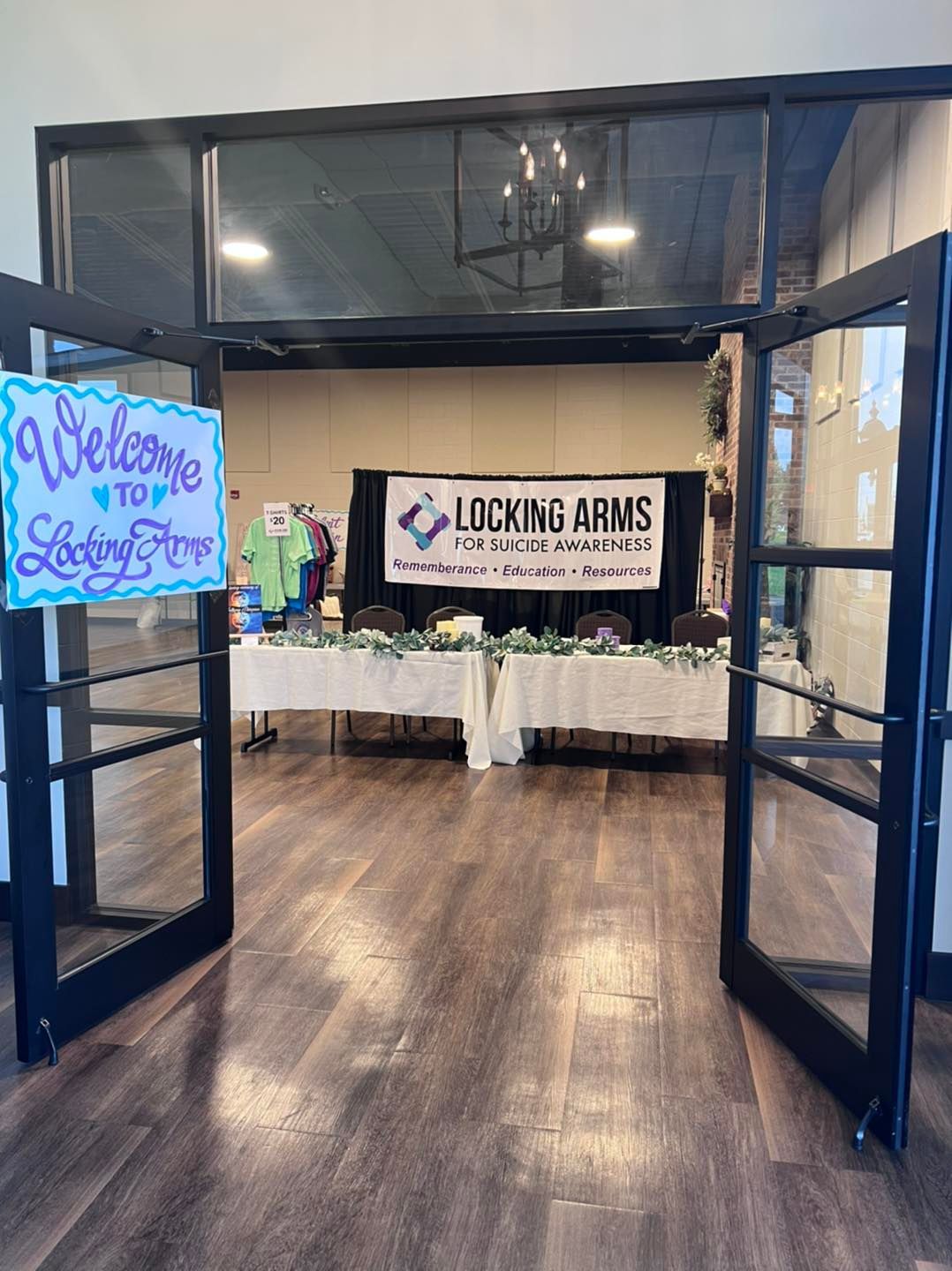 A group of people are putting their hands together in a huddle.