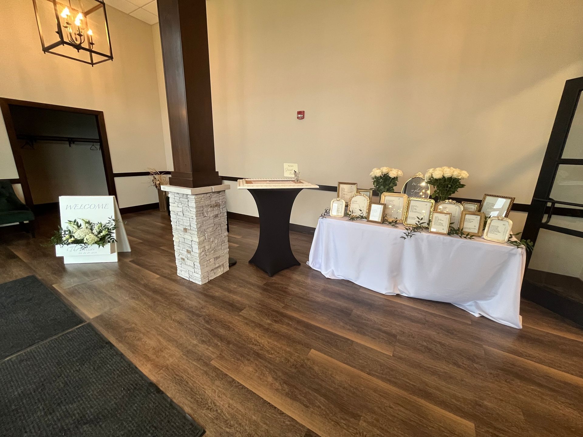 There is a table with flowers on it in the middle of the room.