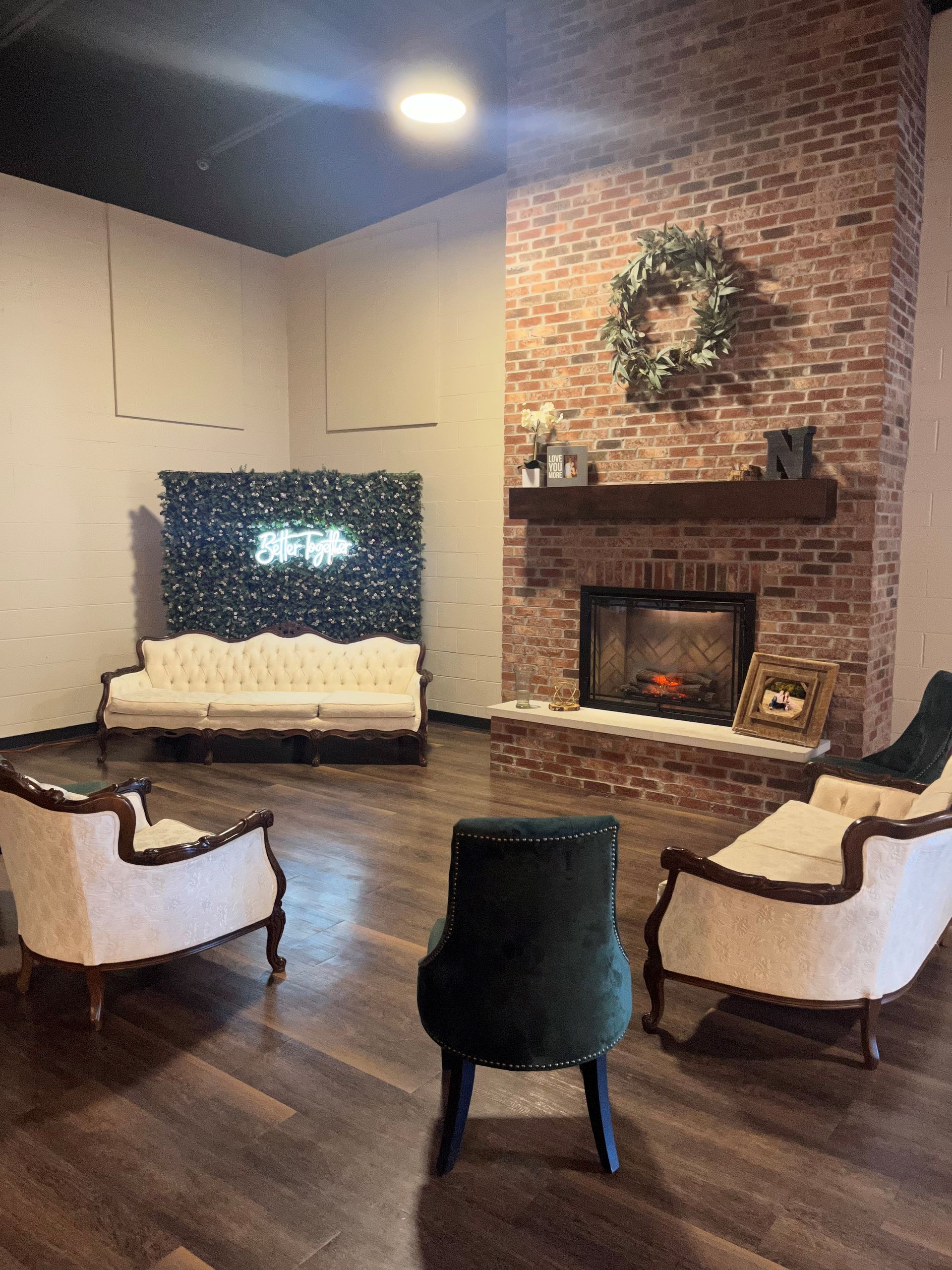 A living room with a fireplace , chairs and a couch.