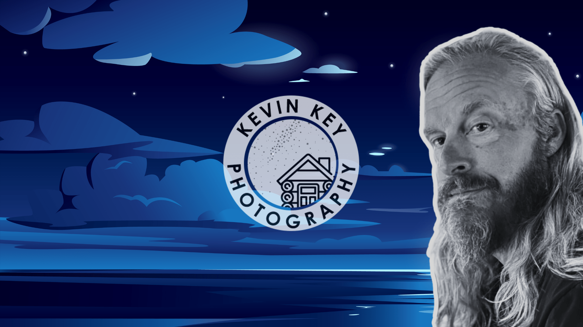 A man with long hair and a beard is standing in front of a logo for kevin key photography