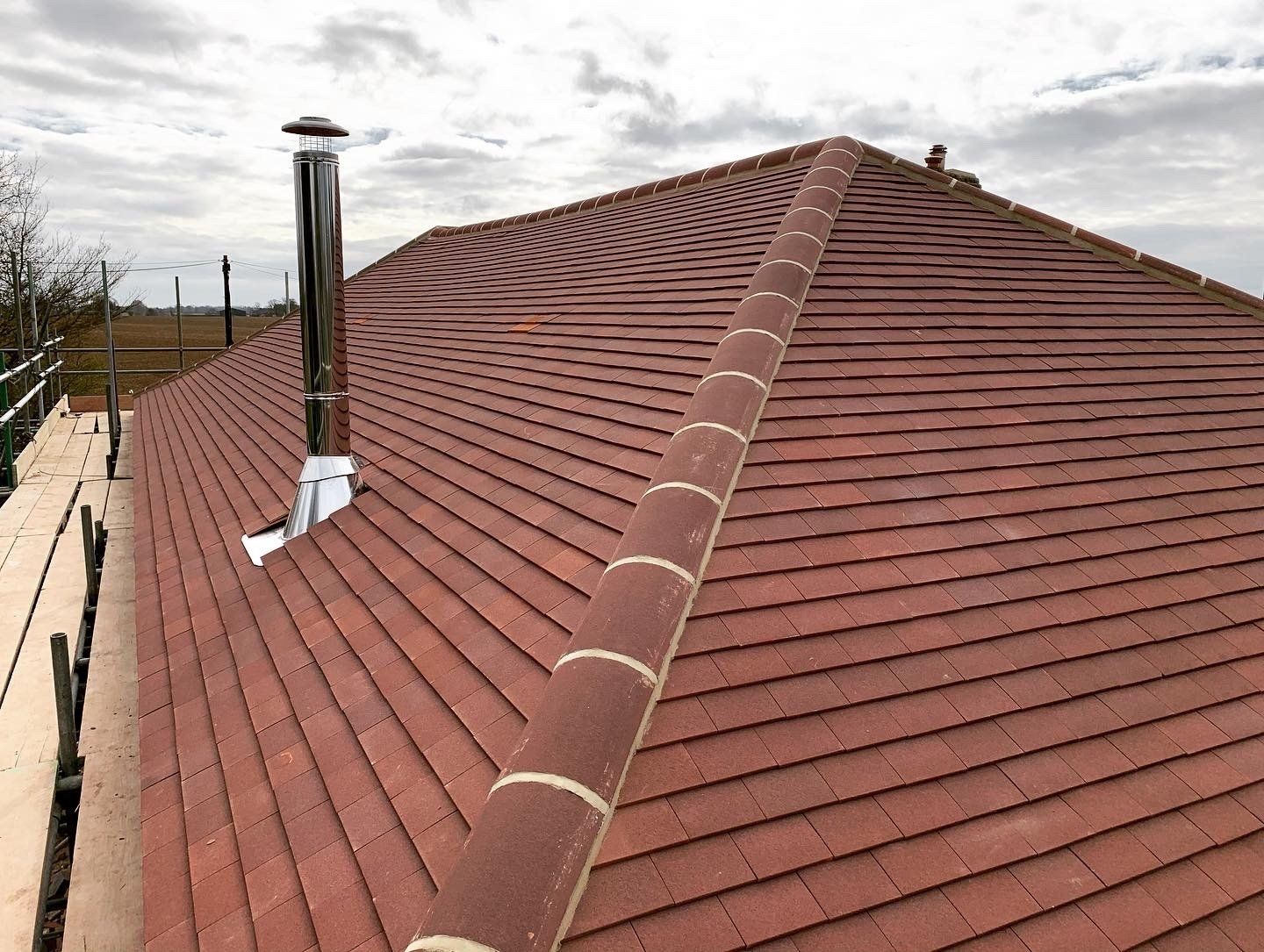 Brown plain tiled roof with chimney chrome cowl and stunning ridgeline