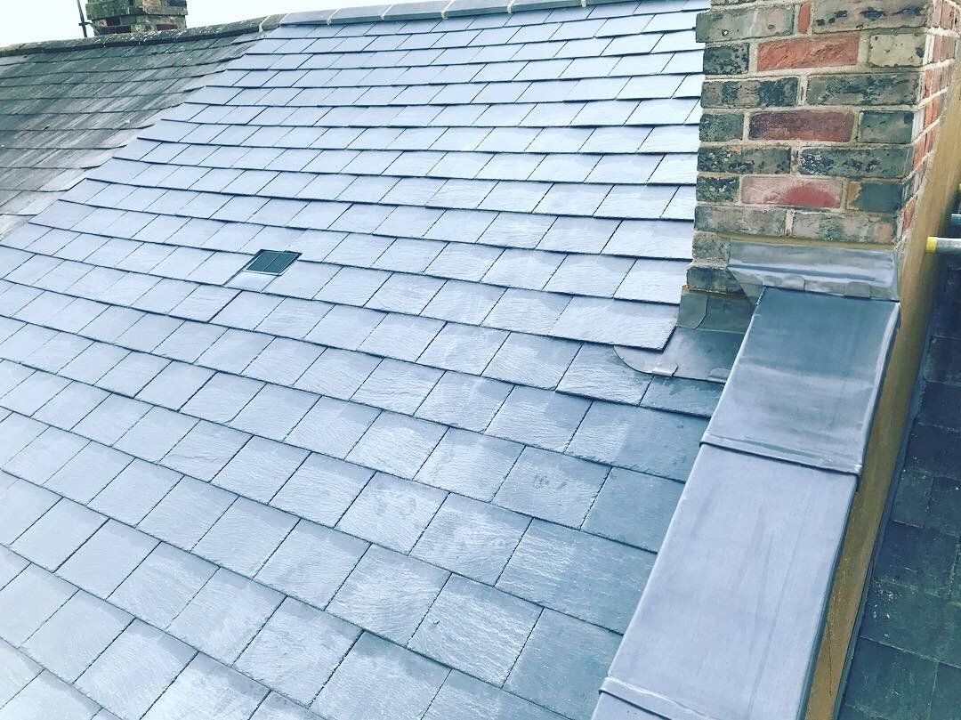 Slate roof with lead detailing