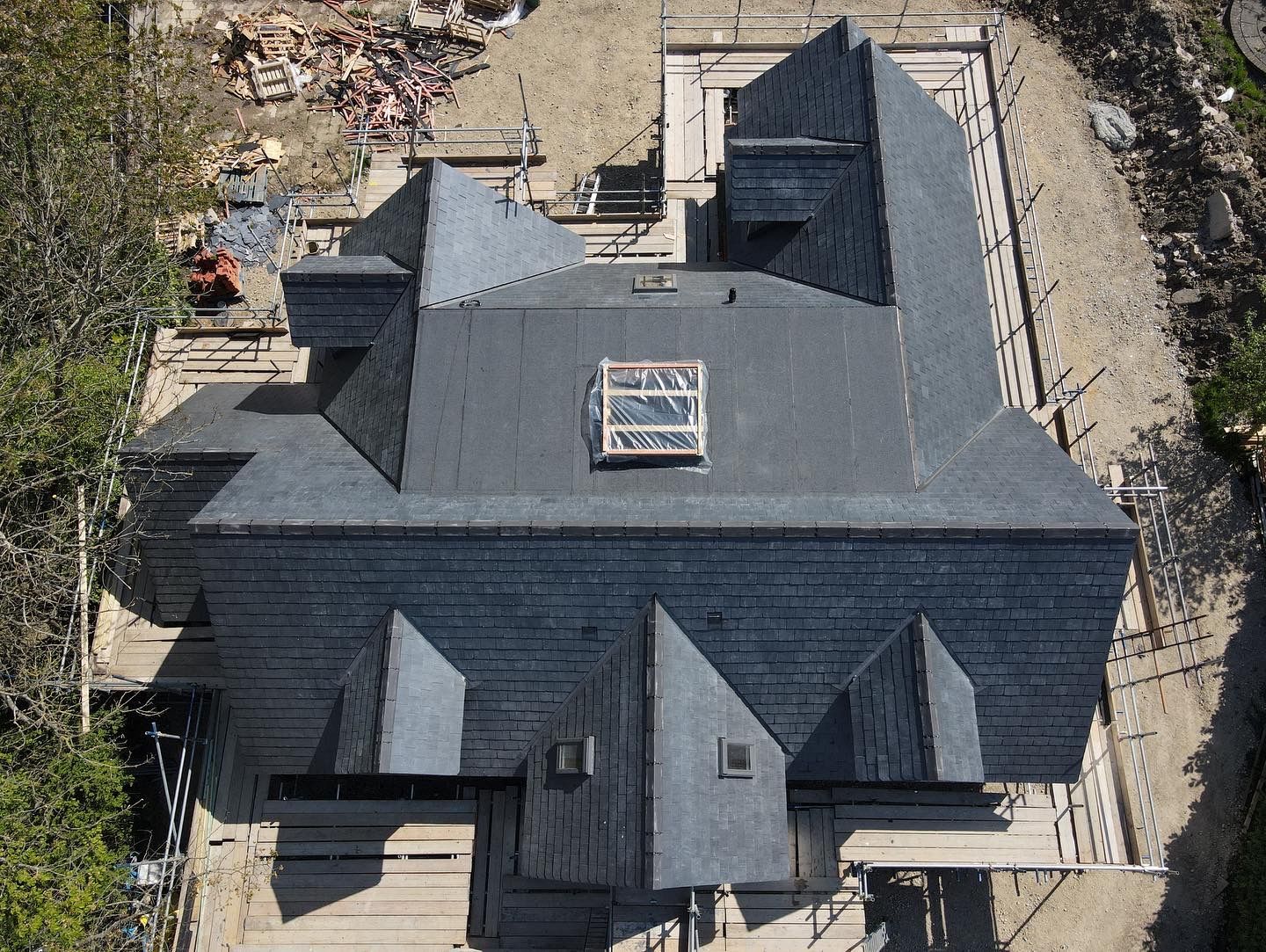 Large spanish slate roofwith dormer windows and skylights