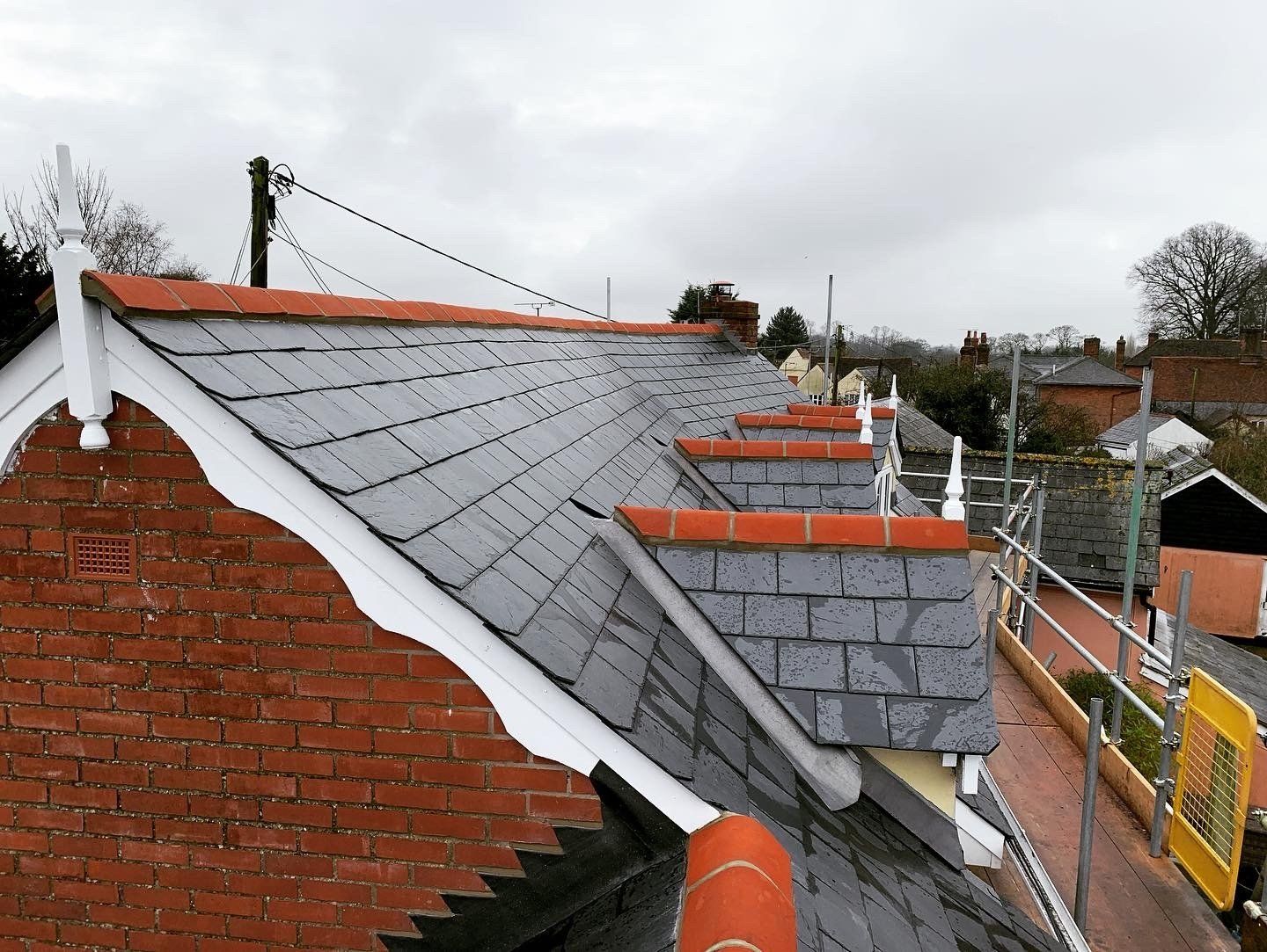Slate roof with white fascia and dormers