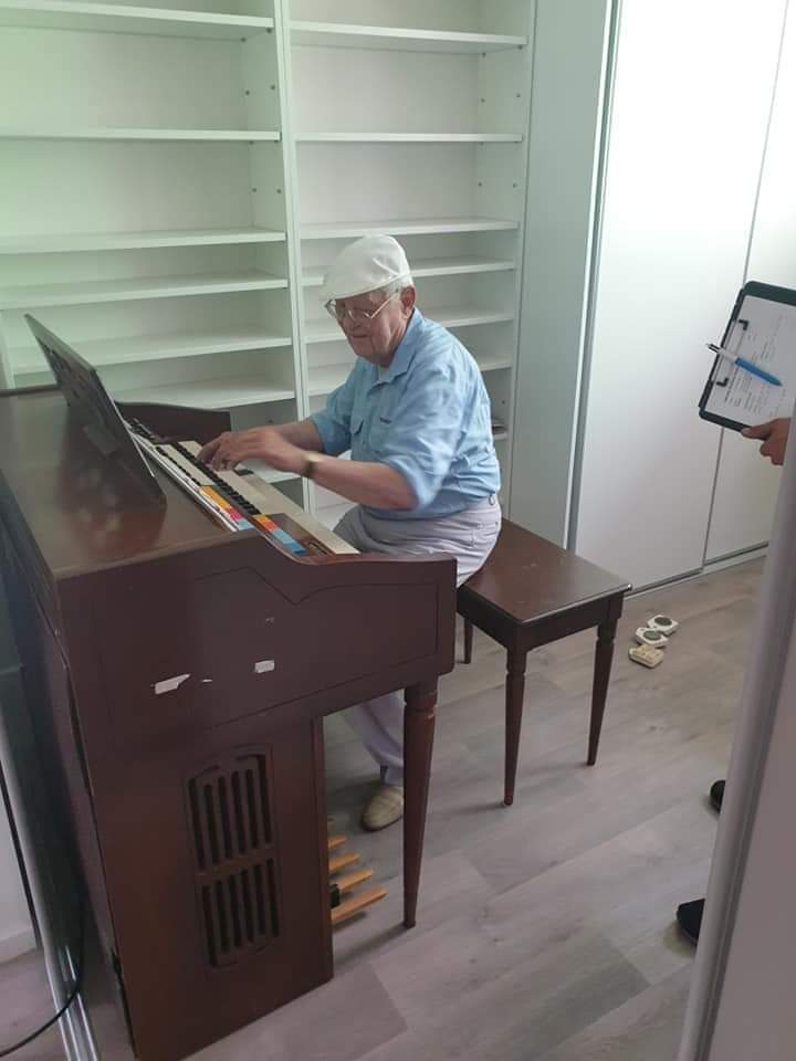 old man playing piano